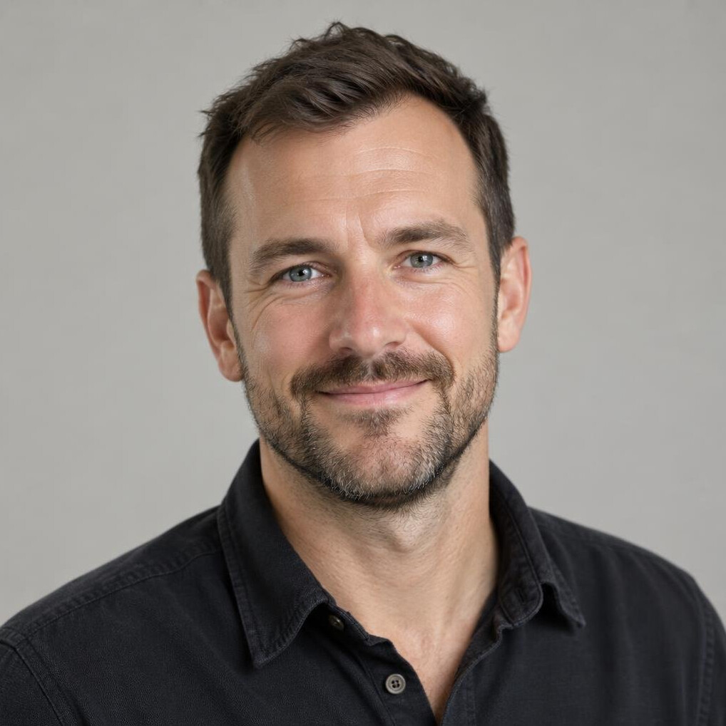 Studio portrait of a bearded man in a casual shirt